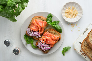 Sandwiches with salted salmon, avocado guacamole, red onions and basil. Smorrebrod. Set of danish...