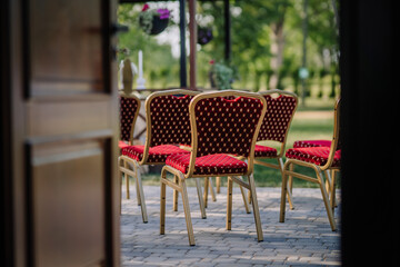Red elegant chairs assembled in the yard for the concert