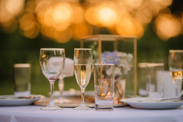 empty glasses on the wedding table at sunset