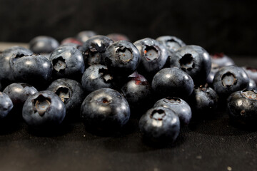 appetizing berries of ripe blueberries on a dark background
