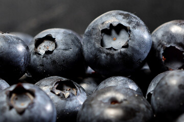 appetizing berries of ripe blueberries on a dark background