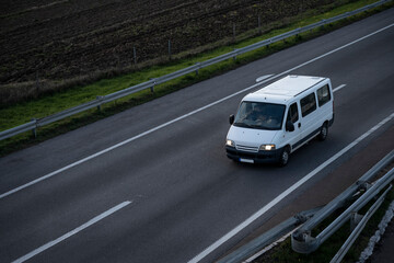 White delivery van on the highway. White modern delivery small shipment cargo courier van moving...