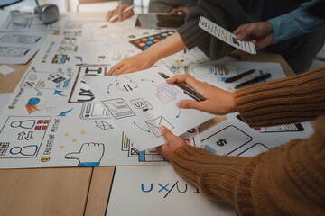 Close up ux developer and ui designer brainstorming interface wireframe design.Creative digital...