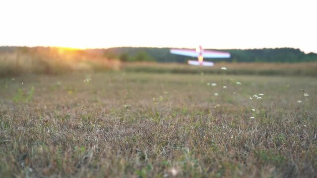 A radio-controlled model of an airplane on takeoff and flying in nature