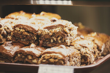 chocolate cookies. assortment baked pastry in bakery. Various Different Types Of Sweet Cakes In Pastry Shop Glass Display. Good Assortment Of Confectionery.