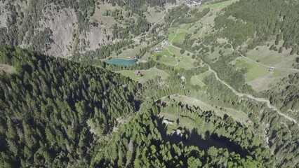View over the forests in the Binn valley with the Ze Binne reservoir and the village of Binn, aerial view, Binn, Valais, Switzerland, Europe