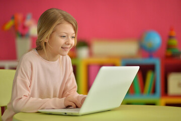 cute girl using laptop at home