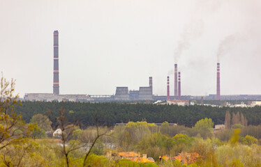 Fototapeta na wymiar Smoke from the chimneys of a power plant in autumn