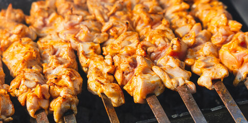 Cooking meat skewers on skewers on the grill