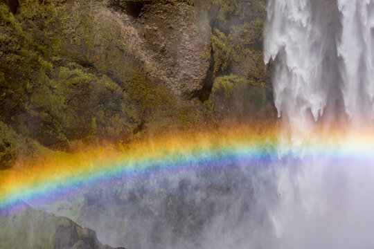 Icelandic waterfall in rainbow, partial view. Southern Iceland, travel photography destination
