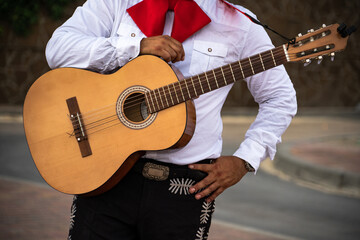 Musician plays the guitar on a city street.