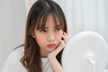 Young woman are worried about faces Dermatology and allergic to steroids in cosmetics. sensitive skin, red face from sunburn, acne, allergic to chemicals, rash on face. skin problems and beauty