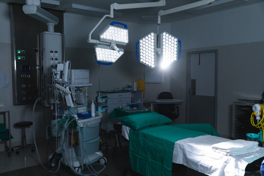 General view of operating theatre with surgical table, equipment and lamps