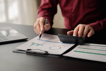 Business men are looking at the company's financial documents to analyze problems and find solutions before bringing the information to a meeting with a partner. Financial concept.