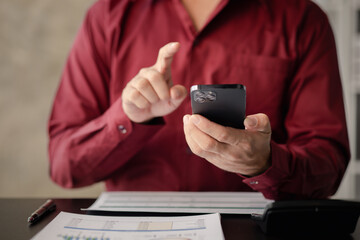A person holds a mobile phone to use social media on a smartphone, communicating via the Internet on a smartphone. The concept of using technology in communication..