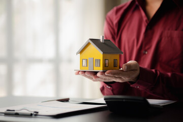 House sales representatives, sales representatives recommend housing details in the project to customers who are interested in viewing the houses in the project. Real estate trading concept.