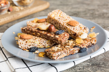 Various granola bars on table background. Cereal granola bars. Superfood breakfast bars with oats,...