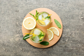 Caipirinha, Mojito cocktail, vodka or soda drink with lime, mint and straw on table background. Refreshing beverage with mint and lime in glass top view flat lay