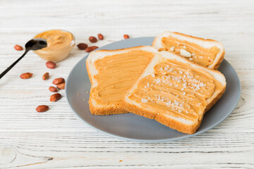 Peanut butter sandwiches or toasts on light table background.Breakfast. Vegetarian food. American cuisine top view vith copy space