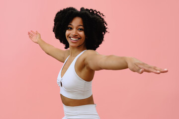 Woman wearing sportswear stretching with arms out