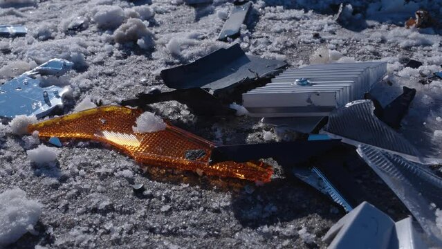 Pieces of a smashed Toyota Rav 4car after a car accident on the snowy road