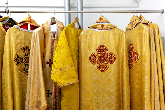 Liturgical clothes, liturgical vestments, robes, hanging on hangers.