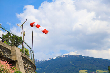 A windsock is blowing in the alps mountains