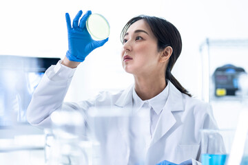 A female scientist conducting research with a petri dish