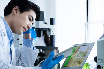 A male scientist conducting research with digital tablet