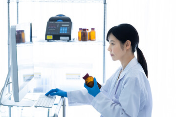 A female scientist conducting research with a computer