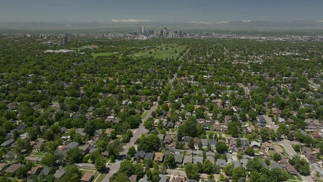 Downtown Denver homes City Park museum Golf Course cityscape Rocky Mountain landscape 14ers Mount Evans aerial drone cinematic foothills Colorado spring summer green lush forward pan up movement