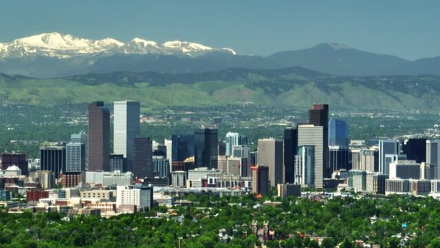 Downtown Denver aerial drone City Park cityscape Nuggets Avalanche Rockies Rocky Mountains landscape Mount Evans cinematic parallax foothills Colorado spring summer green lush circling right movement