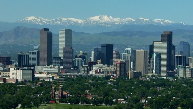 Downtown Denver aerial drone City Park cityscape Nuggets Avalanche Rockies Rocky Mountains landscape Mount Evans cinematic parallax foothills Colorado spring summer green lush circling left movement