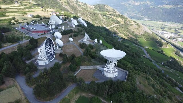 Teleport and data center in leuk in the valley of valais, satellite dishes in idyllic swiss scenery with green landscape