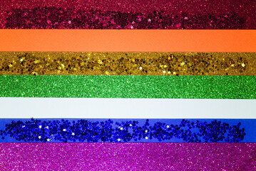 Abstract paper gradient background in bright colors. LGBT color festive background with shiny particles, rainbow colorful photo for bright design. Gay lesbian transgender background