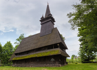 Fototapeta na wymiar Gothic wooden church with tower in Sokyrnytsia village, Ukraine