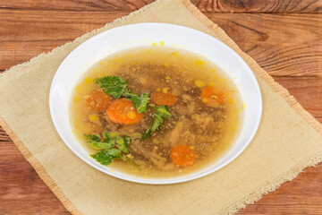 Chicken jelly in the white bowl on the rustic table