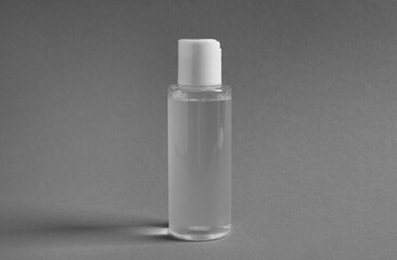 Fototapeta na wymiar Transparent bottle with cosmetic product on grey background