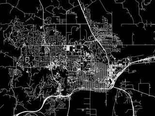 Vector road map of the city of  Manhattan Kansas in the United States of America with white roads on a black background.