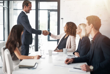 Business people, handshake and meeting for teamwork, agreement or partnership in conference at the office. Businessman shaking hands with woman for b2b, corporate growth or hiring at the workplace