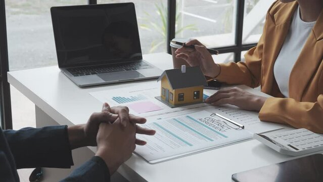 Lawsuits against Real estate agent and realtor general liability insurance businessman professional discussing and consultant with house toy model building before sign a contract with law concept