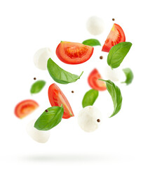Flying salad with mozzarella cheese, tomatoes and basil on white background.