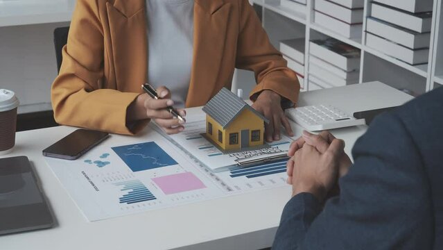 Lawsuits against Real estate agent and realtor general liability insurance businessman professional discussing and consultant with house toy model building before sign a contract with law concept