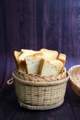 Tea Time Snack. Healthy Wheat rusk served with Indian hot masala tea and milk jug over black background. also known as Mumbai cutting chai. with Copy space. Crunchy rusk or toast.