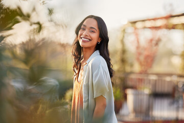 Portrait of beautiful happy woman smiling during sunset outdoor - 617708713