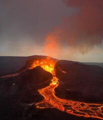 A view of the eruption of Fagradalsfjall volcano in Iceland, with an orange hue emitting from lava - obrazy, fototapety, plakaty