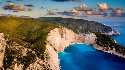 Aerial view of Navagio Beach in Zakynthos, Greece, with a stunning sunset view