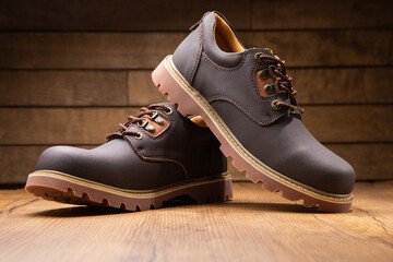 Stylish men's casual work boots for everyday walking in nature and the city on a wooden background stylish concept