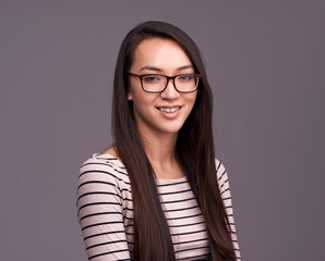 Portrait, fashion glasses and happy woman in studio isolated on a gray background mockup space. Face, nerd and female geek, person or model from Canada with trendy clothes, eyewear and casual style.