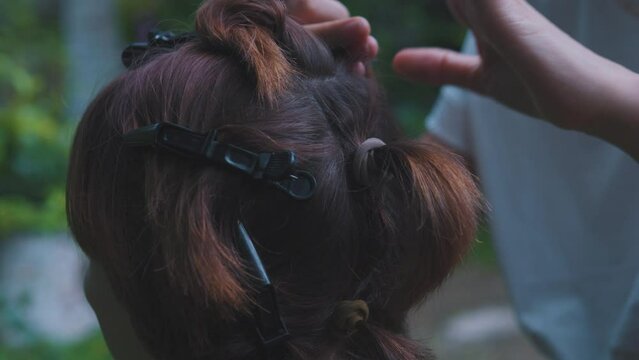 Process of weaving making boxer braids cornrows by a hair braider.